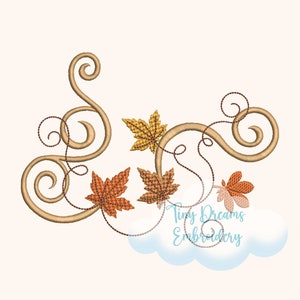 May include: Embroidered design featuring a brown vine with fall leaves in shades of orange, yellow, and red. The vine is decorated with swirls and curls. The design is perfect for fall crafts and projects.