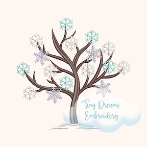 May include: Embroidered design of a brown tree with blue and white snowflakes. The tree is standing in a cloud of white snow. The text "Tiny Dreams Embroidery" is below the tree.