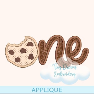 May include: An applique design featuring the word "one" with a cookie-themed design. The "one" is made of brown frosting with sprinkles, and the "o" is a bitten cookie with chocolate chips. The design includes the text "Tiny Dreams Embroidery" and the word "APPLIQUE".
