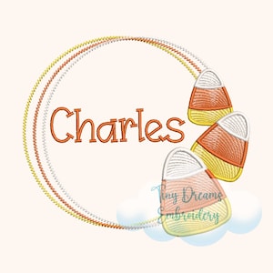 May include: An orange, yellow and white candy corn embroidery design with the name "Charles" in a circle of gold, silver and orange thread. The design is on a white background with a blue cloud and the text "Tiny Dreams Embroidery" in the bottom right corner.