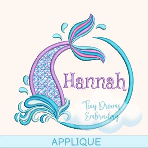 May include: A blue and purple mermaid tail applique with a circle around it. The name "Hannah" is written inside the circle. The text "Tiny Dreams Embroidery" is below the circle. The word "APPLIQUE" is at the bottom of the image.