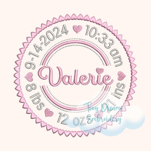May include: Embroidered pink and silver birth announcement with the name "Valerie", date, time, weight (8 lbs 12 oz), and length (21 ins). The design is circular, with a heart-shaped border and accents.