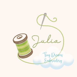 May include: A green and brown embroidery thread spool with a needle and thread, a green cursive font spelling "Julia" and a white cloud with the text "Tiny Dreams Embroidery".