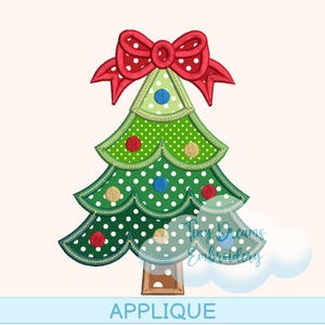May include: A green Christmas tree applique with white polka dots and a red bow. The tree has a brown trunk and is decorated with red, blue, and gold ornaments. The word "APPLIQUE" is written in blue at the bottom.