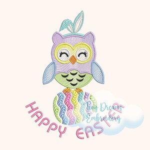 May include: An embroidered owl wearing bunny ears, sitting on a colourful Easter egg. The owl is in shades of purple, green, and yellow, with the words "HAPPY EASTER" in pink below. A whimsical design for Easter.