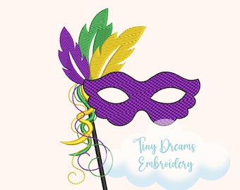 May include: A purple Mardi Gras mask with a black handle, adorned with green, yellow, and purple feathers. The mask is embellished with swirling green and yellow beads. The text "Tiny Dreams Embroidery" is displayed in a cloud-shaped design.