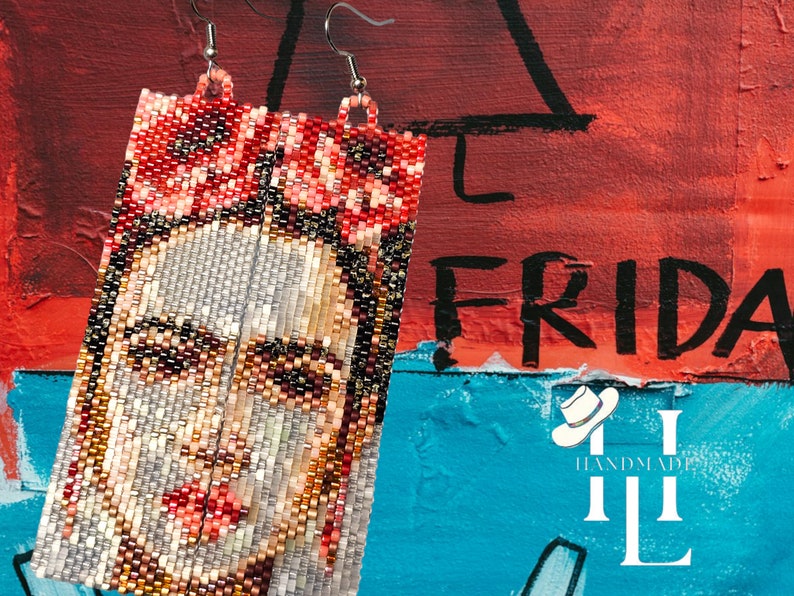 May include: A pair of beaded earrings featuring a colorful portrait of Frida Kahlo. The earrings are rectangular in shape and are made with small, colorful beads. The background is a red, blue, and white painted wall with the word "FRIDAY" written in black.