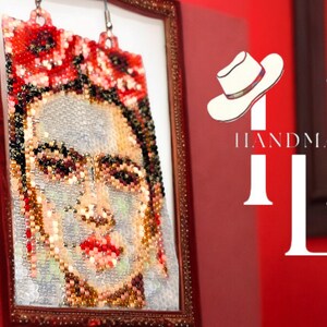 May include: A framed beaded portrait of Frida Kahlo with red flowers in her hair. The frame is gold and the background is red with the text "HANDMADE" and a white hat.