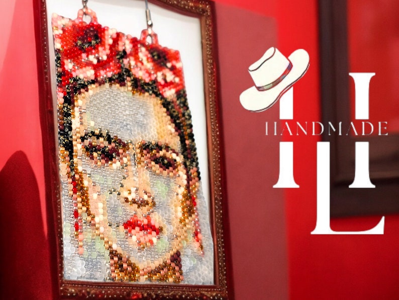 May include: A framed beaded portrait of Frida Kahlo with red flowers in her hair. The frame is gold and the background is red with the text "HANDMADE" and a white hat.