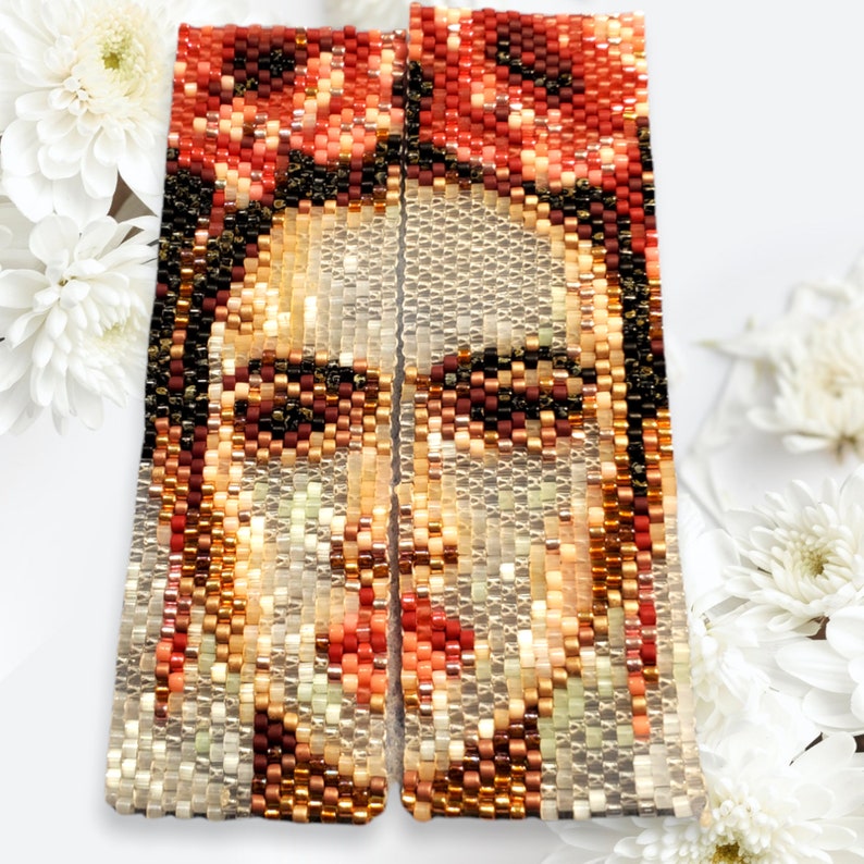 May include: A pair of beaded earrings featuring a portrait of Frida Kahlo. The earrings are made with small, colorful beads and are rectangular in shape.