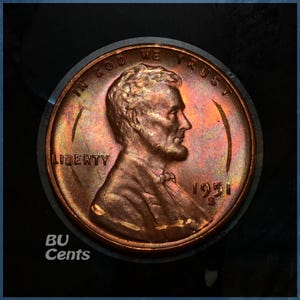 May include: A copper-colored 1951 Lincoln penny, with the profile of Abraham Lincoln. The coin is in a protective case. The words "IN GOD WE TRUST" and "LIBERTY" are visible. The text "BU Cents" is in the lower left corner.