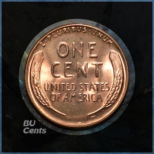 May include: A copper-colored United States one-cent coin. The coin features the words "ONE CENT" in large letters, with "UNITED STATES OF AMERICA" below. The coin is surrounded by a circular border with the words "E PLURIBUS UNUM".