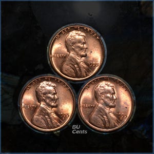 May include: Three copper-colored 1955 Lincoln pennies arranged in a triangle. Each coin features a profile of Abraham Lincoln, the word "LIBERTY", and the year "1955". The phrase "IN GOD WE TRUST" is also visible on each coin. The text "BU Cents" is also visible.