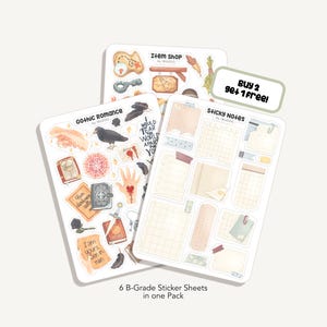Könnte beinhalten: Drei Stickerbögen mit verschiedenen Designs. Einer trägt die Aufschrift "Item Shop" mit Illustrationen von Schlüsseln und Federn. Ein weiterer ist "Gothic Romance" mit Illustrationen von Raben und Händen. Der dritte ist "Sticky Notes". Der Text "Buy 2 get 1 free!" ist ebenfalls sichtbar.