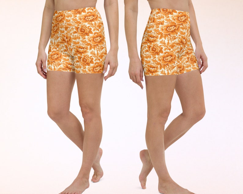 May include: A pair of athletic shorts with a floral print in shades of orange and white. The shorts are made of a stretchy, comfortable fabric and have a high waist.