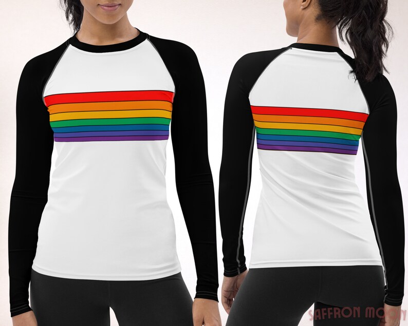 May include: A white long-sleeve shirt with black sleeves and a rainbow stripe design across the chest. The shirt is made of a stretchy, moisture-wicking fabric.