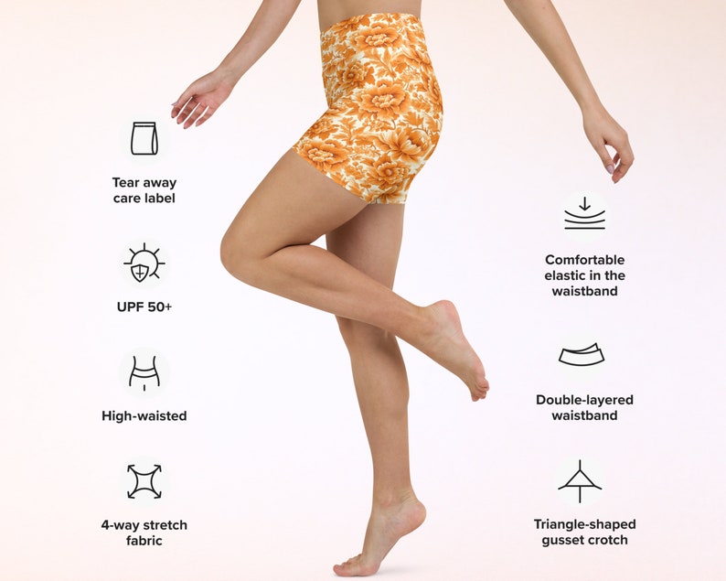 May include: A woman wearing high-waisted shorts with a floral print. The shorts have a double-layered waistband, a triangle-shaped gusset crotch, and 4-way stretch fabric. The shorts also have a tear-away care label and offer UPF 50+ sun protection.