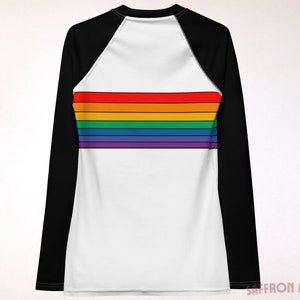 May include: A white long-sleeve shirt with black raglan sleeves and a rainbow stripe design across the chest.