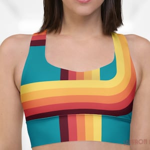 May include: A teal, yellow, orange, and red striped sports bra with a racerback design.