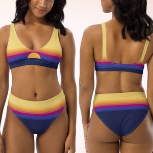 May include: A yellow, orange, pink, and blue striped bikini with a sunset design. The top has a scoop neck and the bottom is high-waisted.