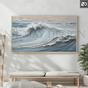 May include: A framed abstract painting of a large ocean wave in shades of blue and gray. The wave is depicted in a layered, textured style, creating a sense of depth and movement.
