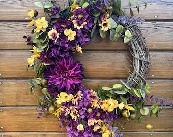 Lush wreath for front door in purple and yellow tones, with sunflowers and assorted autumn foliage. Unique wreath for year round decor.