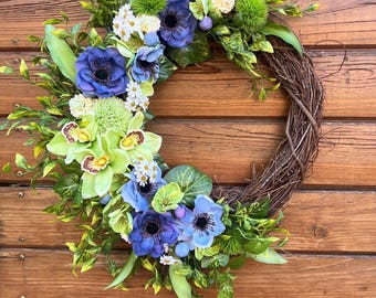 Bestselling Spring wreath for front door in green and lavender tones. Blue, lavender, and green flowers. Fun door decor.