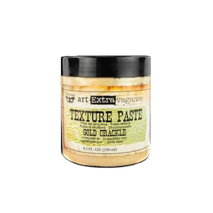 May include: A round jar of gold texture paste labeled "art Extra vagance Texture Paste Gold Crackle" with the text "Pâte de structure Pasta relieve Pasta di struttura Structuurpasta craquelé or screpolato oro agrietado oro Gold risse 8.5 FL. OZ. (250 ml)"