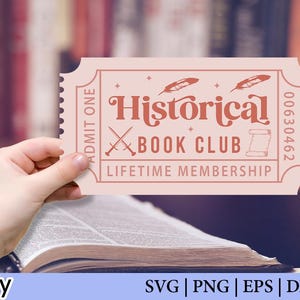 May include: A pink ticket with the words "Historical Book Club Lifetime Membership" in a vintage font. The ticket has a decorative design with crossed swords and feathers. The ticket is held over an open book.