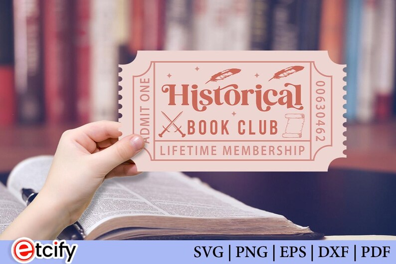 May include: A pink ticket with the words "Historical Book Club Lifetime Membership" in a vintage font. The ticket has a decorative design with crossed swords and feathers. The ticket is held over an open book.