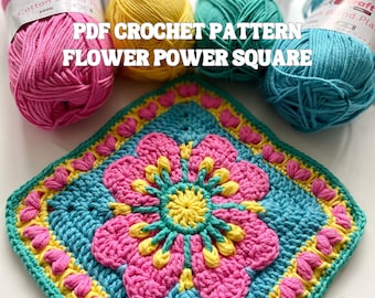 Può includere: Uno schema all'uncinetto per un quadrato "Flower Power". Il quadrato è realizzato con filato turchese, rosa e giallo. Lo schema si chiama "Flower Power Square" ed è disponibile per il download in PDF.