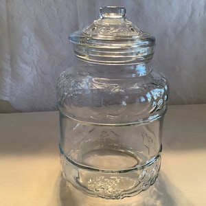 Vintage KIG Indonesia clear glass cookie jar or canister with lid embossed with a fruit design