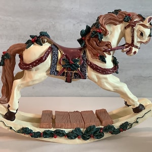 Vintage World Bazaars, Inc. Holiday Treasures musical rocking horse figurine.  Plays the tune “Jingle Bells”
