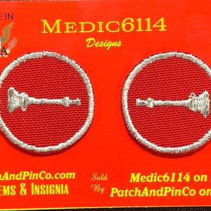 May include: Two red embroidered patches with white outlines, each featuring a silver-colored image of a wrench and a pipe. The patches are displayed on a red background with the text "MEDIC6114 Designs" and "PatchAndPinCo.com EMBLEMS & INSIGNIA".