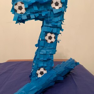 Beautiful handmade number 7 football birthday  piñata to brighten up any party.