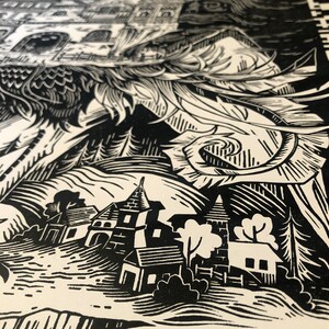 May include: Black and white woodcut print of a village with a castle in the background. The print features a detailed depiction of buildings, trees, and a winding path.