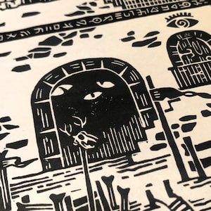May include: Black and white linocut print of a fantastical scene with a large, arched doorway with eyes and a skull with antlers. The doorway is surrounded by bones and a building with a window.