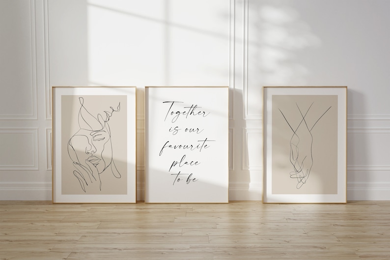 May include: Three framed prints with minimalist line art designs. The left print features a woman's face, the middle print has the text "Together is our favourite place to be", and the right print shows two hands holding each other.