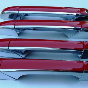 May include: Four red car door handles with chrome accents. The handles are arranged in a row, with the top handle being the furthest away from the viewer.