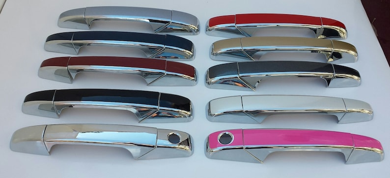 May include: A set of 12 car door handles in various colors, including silver, black, red, beige, gray, white, and pink. The handles are made of chrome and have a modern design.