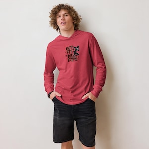 May include: A red long-sleeved hoodie with a black graphic that says "Get Fit or Die Trying!" and a silhouette of a runner. The hoodie has a drawstring hood.