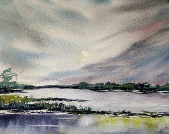 May include: A watercolor painting of a lake with a cloudy sky. The lake is calm and still, and the sky is a soft blue with white clouds. The sun is shining through the clouds, creating a warm glow on the water.