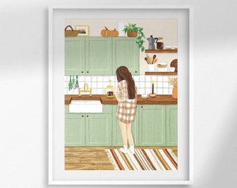 May include: A framed art print depicts a cozy kitchen scene. The illustration features a person in a plaid shirt standing in front of mint green cabinets and a white sink. Wooden countertops, shelves with decor, and a striped rug complete the warm, inviting aesthetic.