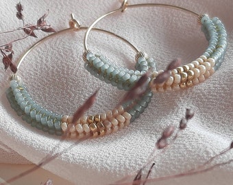 Dangling hoop earrings woven with Japanese glass beads in cream, green and gold boho chic style