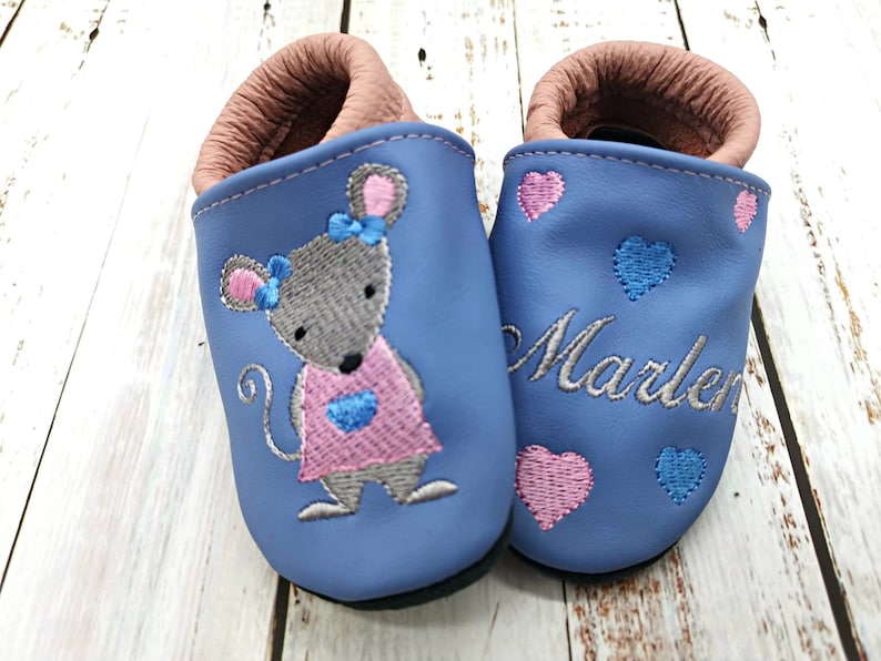 a pair of blue baby shoes with a mouse on them