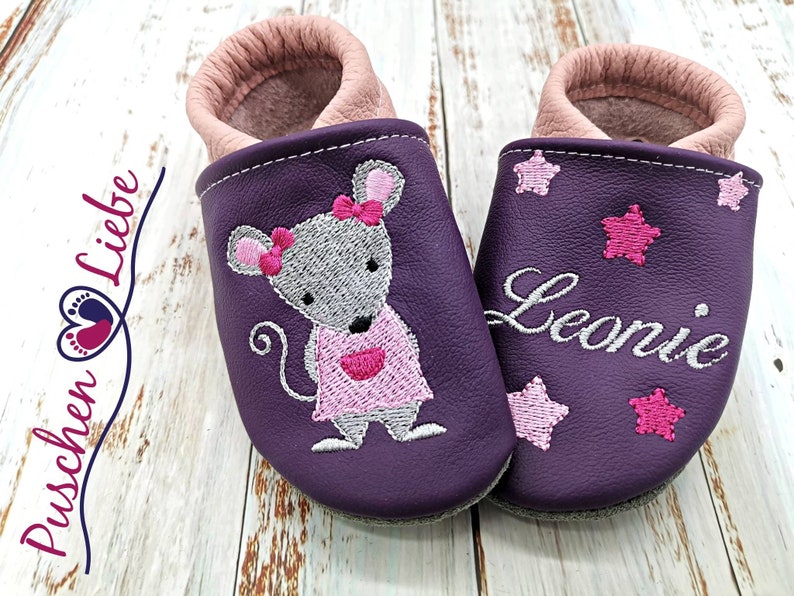 a pair of purple shoes with a mouse on them