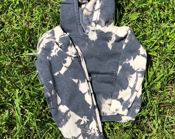 May include: A black and white tie-dye hoodie with a drawstring hood.