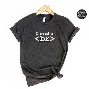 May include: Dark grey t-shirt with the text "I need a <br>" printed in white.