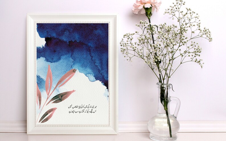 May include: A framed watercolour painting with a blue and pink colour scheme. The painting features a stylised branch with leaves and a quote in Urdu script. The quote reads: "میری زندگی میں کوئی چیز ٹھکانہ پہ نہیں اس تجھے دیکھ کہ لگتا ہے سب اچھا ہے"