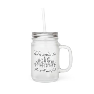 May include: A clear glass mason jar with a silver lid and a handle. The jar has a black and white design with the text "God is within her, she will not fall" and the scripture reference "Psalm 46:5".